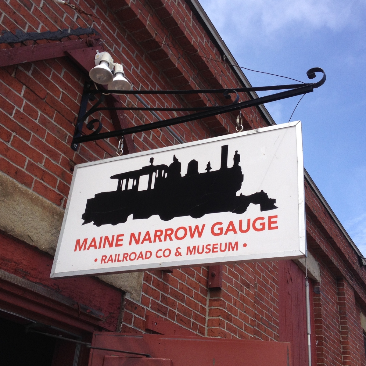 hanging sign with picture of train, for Maine Narrow Gauge Railroad