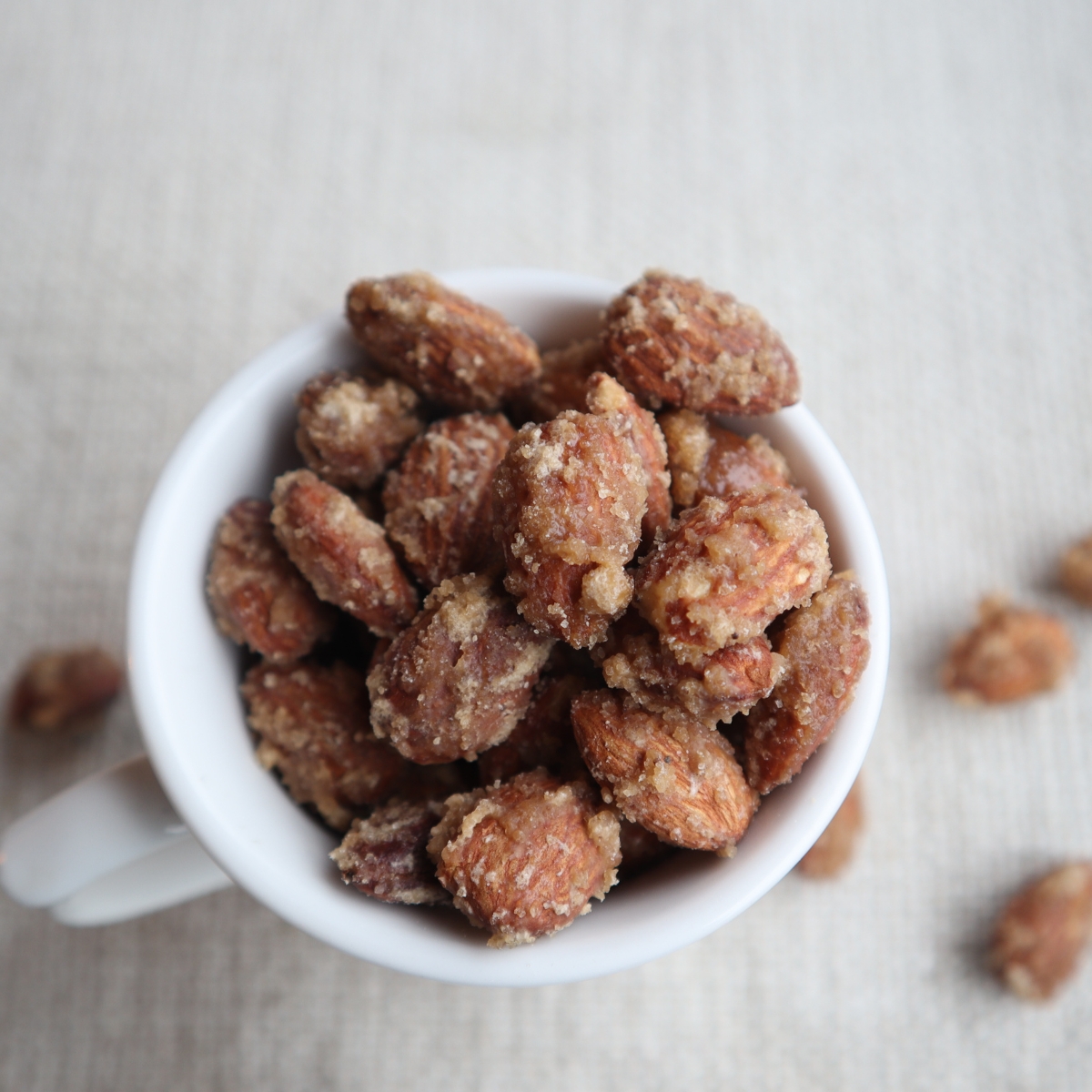 white cup full of brown sugar candied almonds